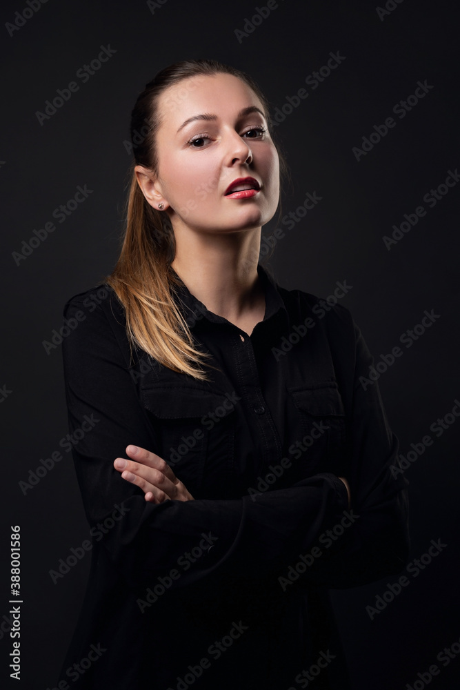 Portrait of a young business woman on a black background