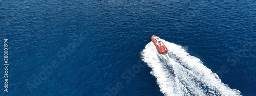 Aerial drone ultra wide photo of small pilot vessel cruising near mediterranean port with deep blue sea