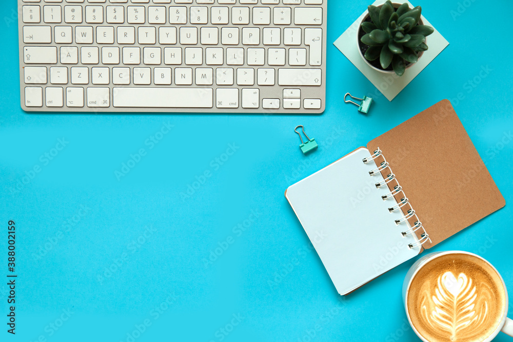 office desk background with smartphone with blank screen mockup, laptop computer, coffee cup and accessories. Top view with copy space, flat lay, on blue table office desk background with smartphone with blank screen mockup, laptop computer, coffee cup and accessories. Top view with copy space, flat lay, on blue table