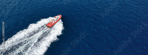 Aerial drone ultra wide photo of small pilot vessel cruising near mediterranean port with deep blue sea