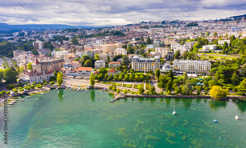 View from Lake Leman of residential areas of Swiss city of Lausanne in cloudy summer day, canton of Vaud in Romandy
