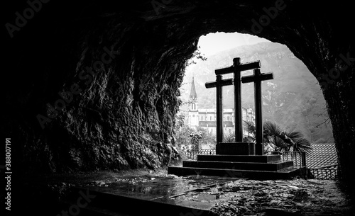Three Christian crosses in a cave. Black and white