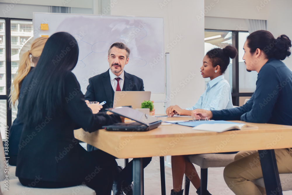 Businesspeople meeting in office teamwork discussing marketing project Businesspeople meeting in office teamwork discussing marketing project