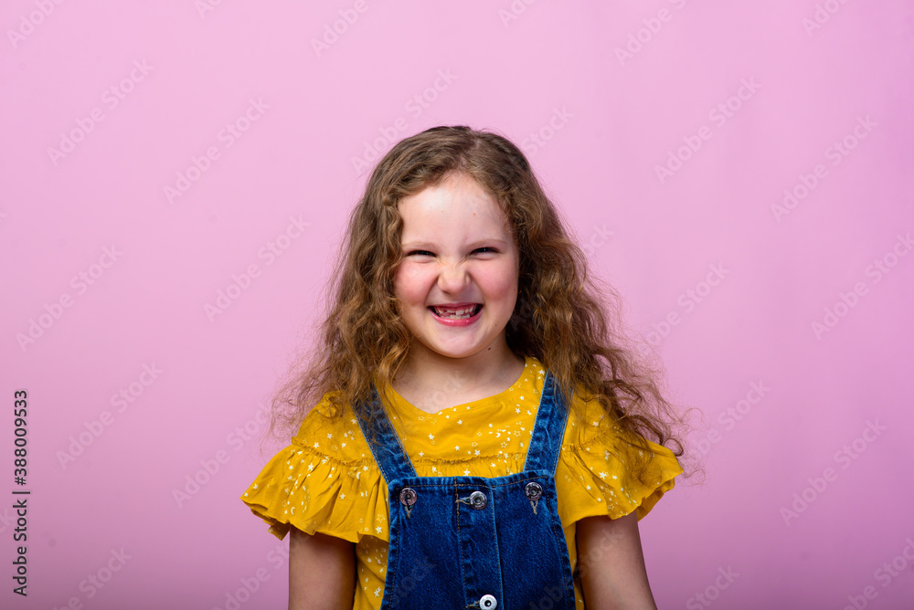 Happy carefree emotions. Energetic joyful adorable little girl laughing at joke on pink background.