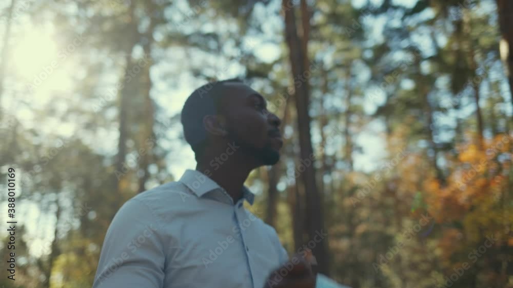 Portrait of African American business man in mask, He took off his mask and breathes freely in the forest. Portrait of African American business man in mask, He took off his mask and breathes freely in the forest.