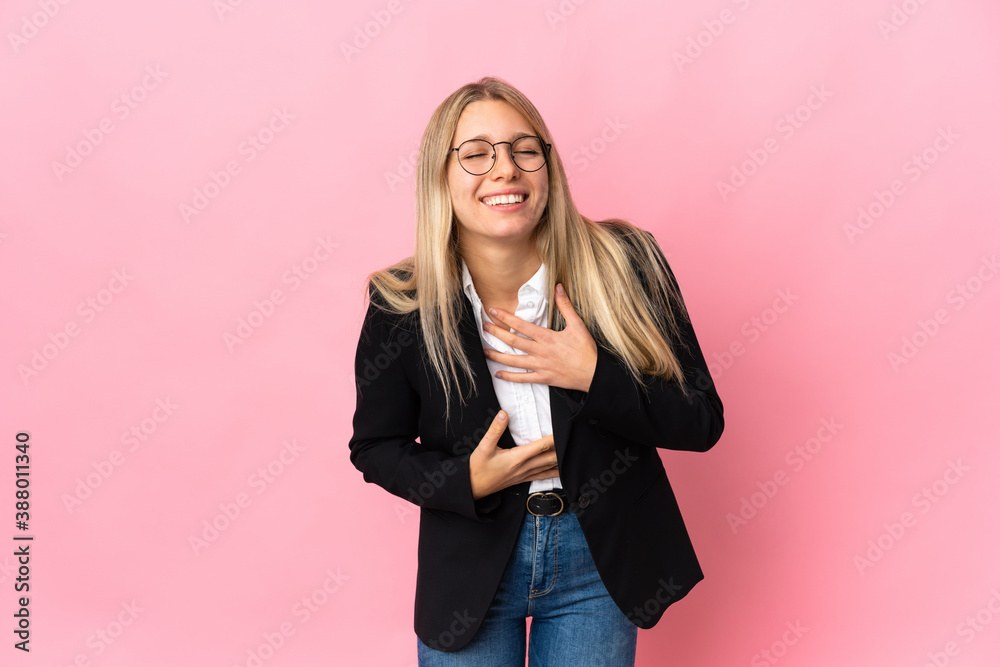 Business blonde woman isolated on pink background smiling a lot Business blonde woman isolated on pink background smiling a lot
