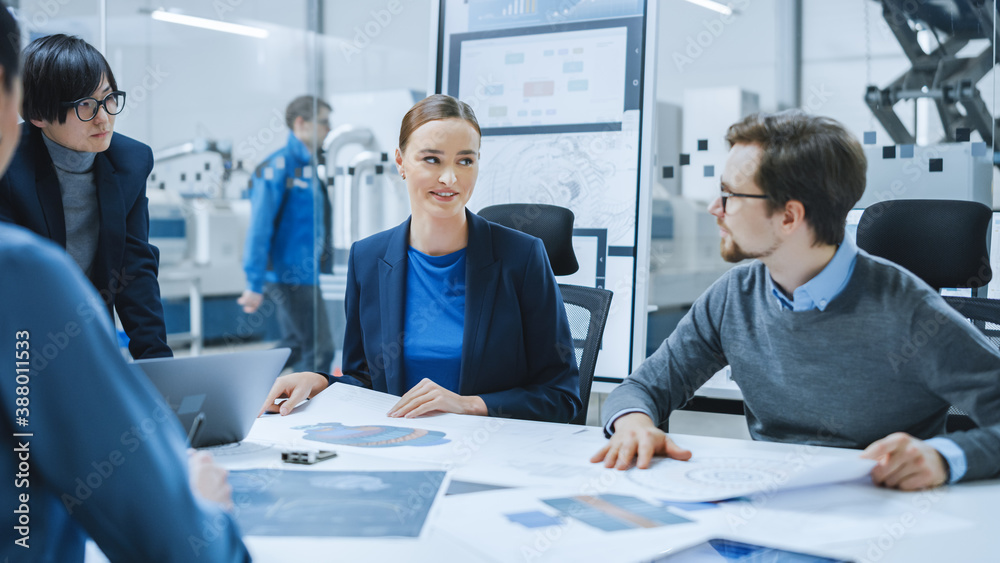 Fototapeta premium Modern Factory Office Meeting Room: Young Female Specialist Reports to Diverse Team of Engineers, Managers, Businesspeople and Investors Sitting at the Conference Table Analyzing Blueprints