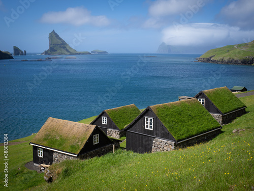Cottages near Böur village, Vágar, Faroe Islands. The cottages are built with inspiration from the old traditional Faroese houses. Stone foundation, white window bars and grass on the roof.