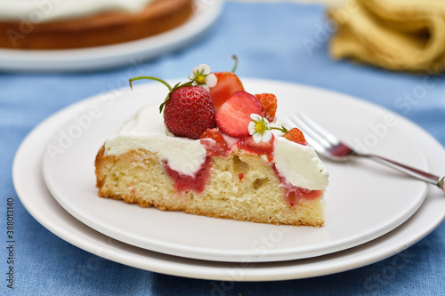 Pie with cream and strawberries on a summer background. . Homemade summer dessert.