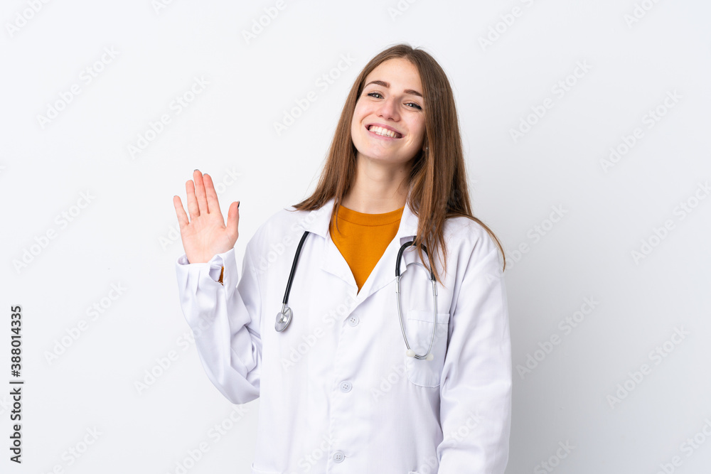 Young woman over isolated background wearing a doctor gown and saluting Young woman over isolated background wearing a doctor gown and saluting