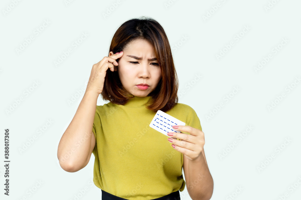 Asian woman forget and confuse to take contraceptive pill with wonder face Asian woman forget and confuse to take contraceptive pill with wonder face