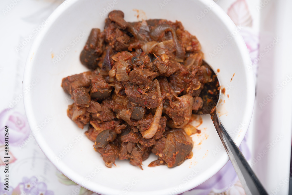 A picture of a locally prepared dish made up of spicy peppered goat known as Asun A picture of a locally prepared dish made up of spicy peppered goat known as Asun