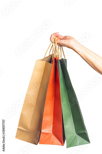 Close-up of hand senior woman holding paper bags with white background. Space for text