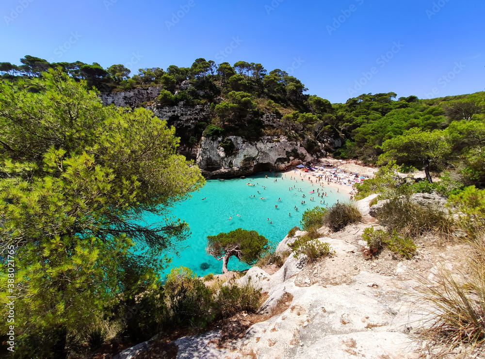 Cala Macarelleta famous paradise beach with turquoise water and pine forests on south coast of Menorca Island, Balearic Islands, Spain.