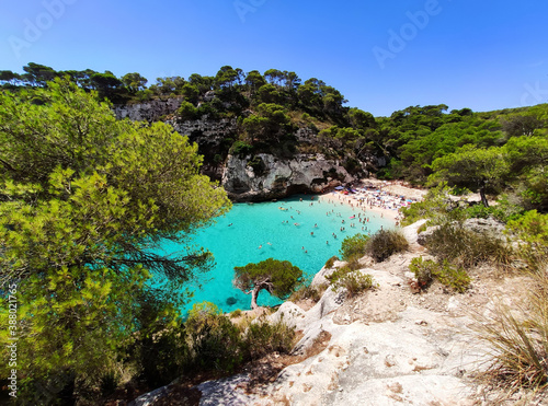 Cala Macarelleta famous paradise beach with turquoise water and pine forests on south coast of Menorca Island, Balearic Islands, Spain.