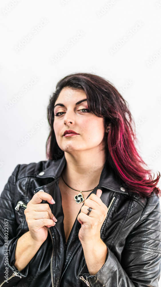 Sexy chubby woman with dyed hair in a leather jacket and with a pendant Sexy chubby woman with dyed hair in a leather jacket and with a pendant