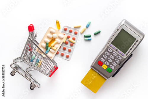 Pharmacy shopping online - grocery cart with medicine and pills