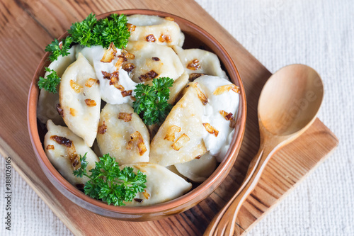 A bowl of russian varenyky, vareniki, Dumplings served with fried onion. Pyrohy - dumplings with filling. View from above, top, overhead. Close-up