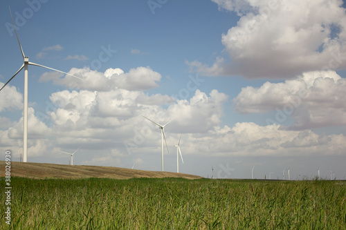 wind turbine alternative energy sourse installed at the field on the sky background photo