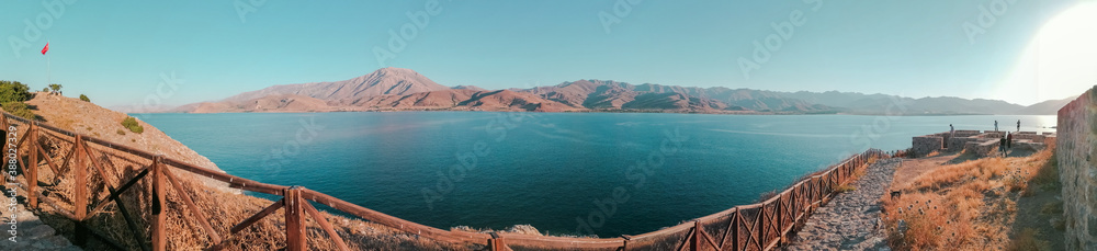 wide angle panoramic landspace with mountains, lake on bridge. 