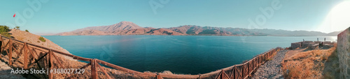 wide angle panoramic landspace with mountains, lake on bridge. 