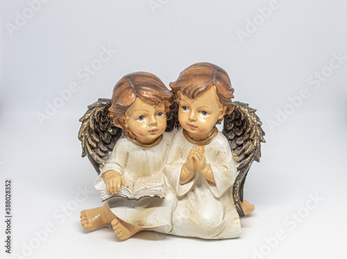 Two angels reading and praying