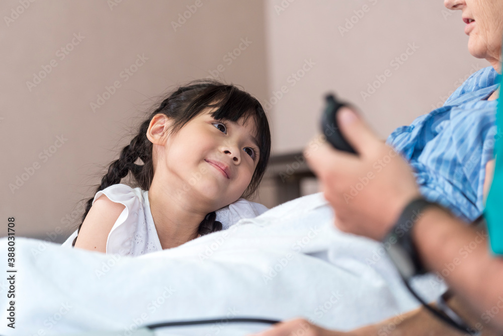 Asian Lovely girl visit and encourage grandmother on patient bed in hospital Asian Lovely girl visit and encourage grandmother on patient bed in hospital