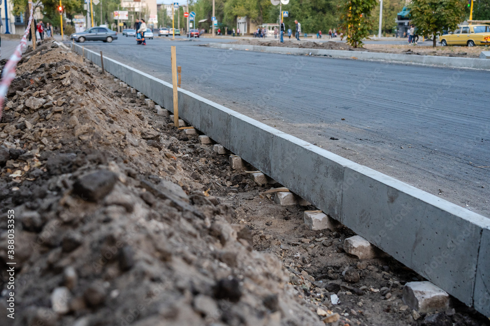 Sidewalk under construction, concrete curb installation. Ukraine