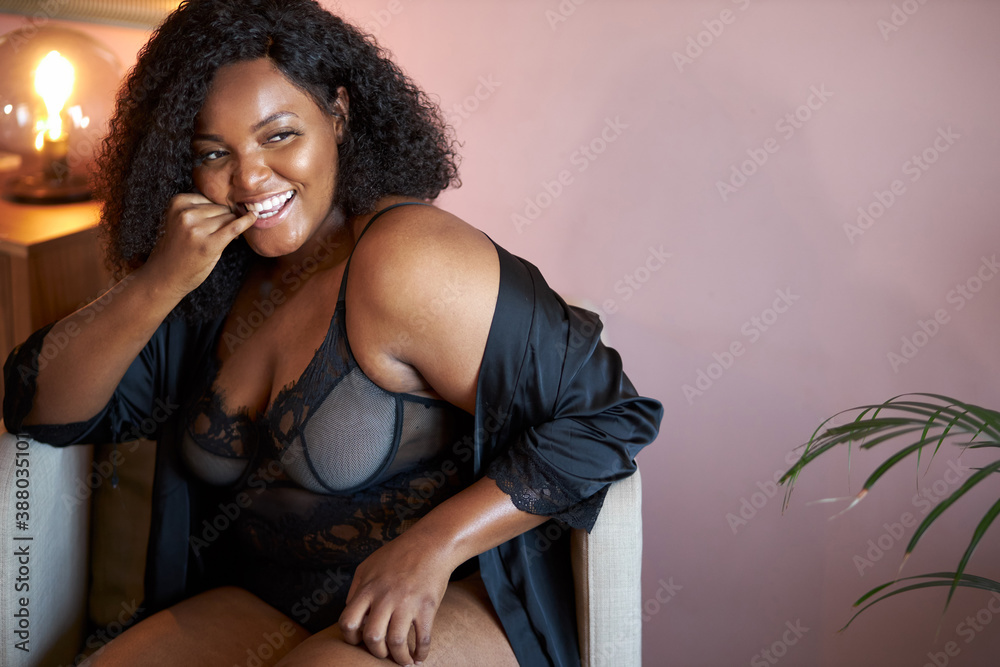 Ταπετσαρία perky african overweight woman has a habit of biting her nails, she sits on armc