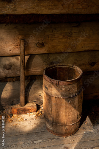 old wooden nail barrel and sledge hammer in log building