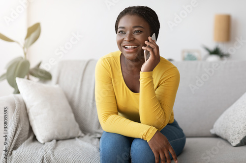 Phone Call. Joyful Young African American Woman Talking On Cellphone At Home