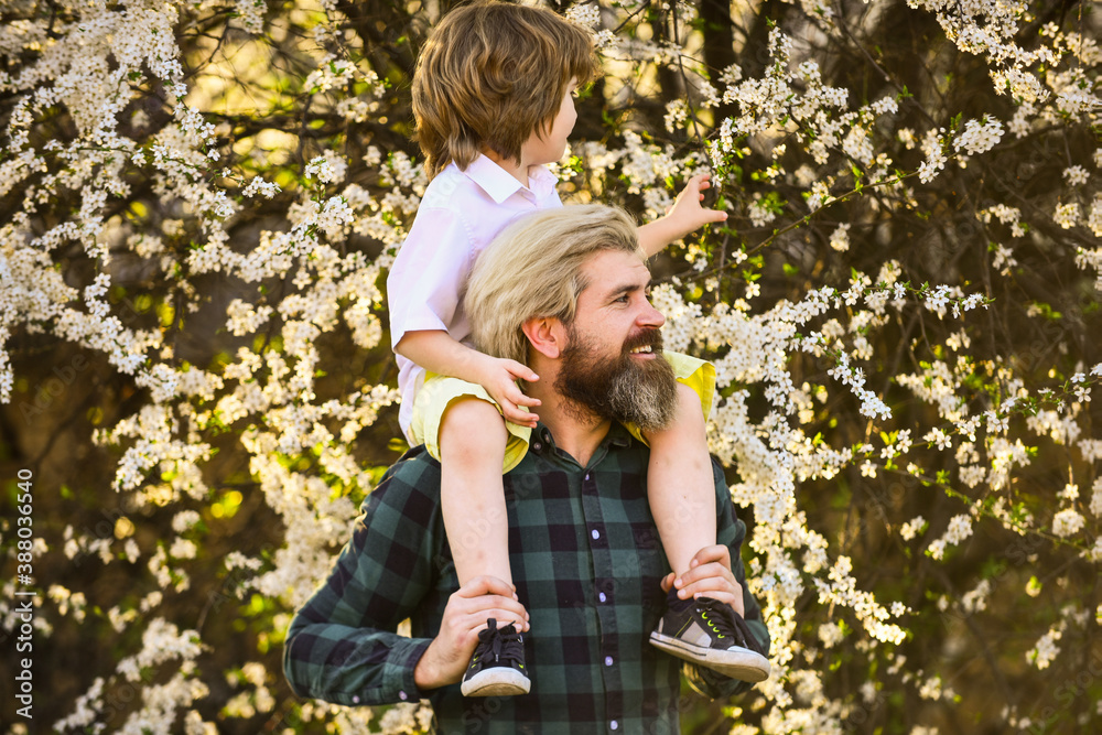 Spring walk. Simple happiness. Happy family. Fatherhood happiness. Fathers day. Little boy and father in nature background. Hipster and baby son. Exploring garden together. Happiness concept Spring walk. Simple happiness. Happy family. Fatherhood happiness. Fathers day. Little boy and father in nature background. Hipster and baby son. Exploring garden together. Happiness concept