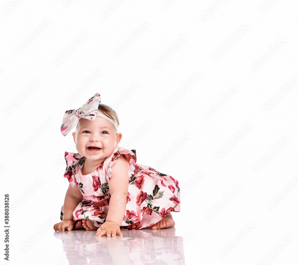Beautiful baby girl crawling on white studio floor Beautiful baby girl crawling on white studio floor