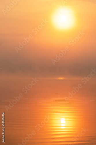 Early morning sunrise with reflection of sun in the Lake