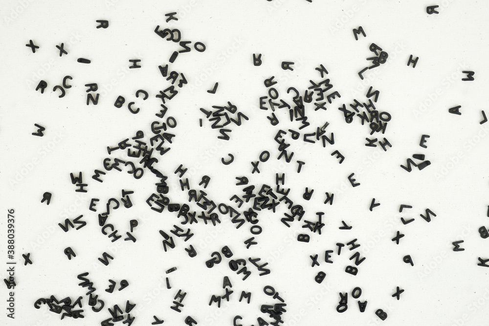Black letters of the alphabet on the white canvass surface Black letters of the alphabet on the white canvass surface