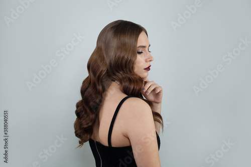 Pretty woman with elegant hairdo on white background