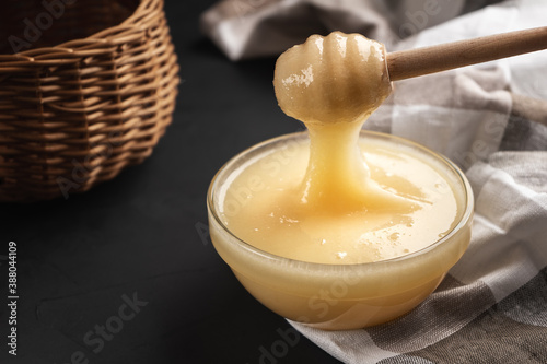 Cream honey is taken with a wooden Mace for honey