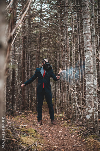 person in the woods man with gas mask and smoke 