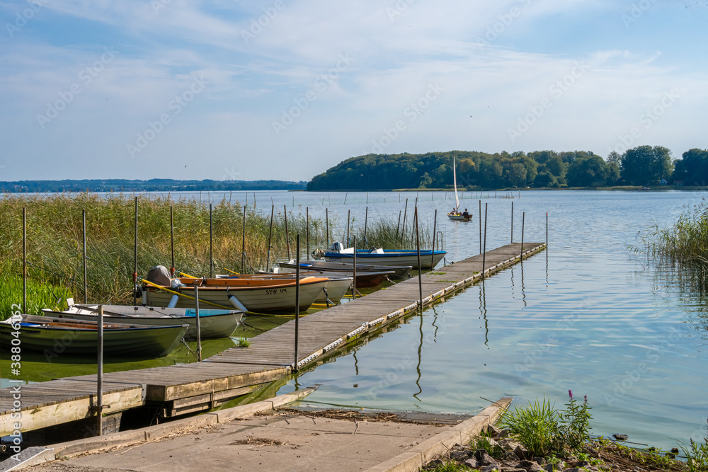 Fototapeta premium A floating jetty and boats in a lake. Picture from Ringsjon, Scania county, Sweden