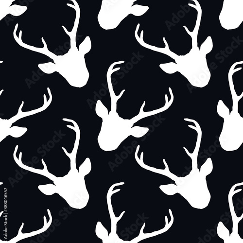 Seamless pattern with deer heads silhouettes