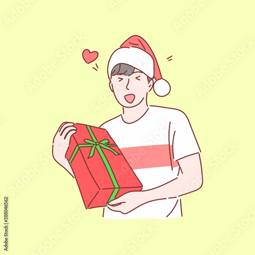 Happy man with Santa hat holding gift box. Hand drawn flat character style.