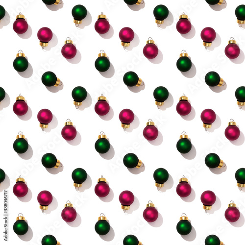 Seamless regular creative pattern with bright shiny little colorful Christmas balls isolated on white