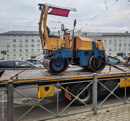 tow truck transports construction equipment