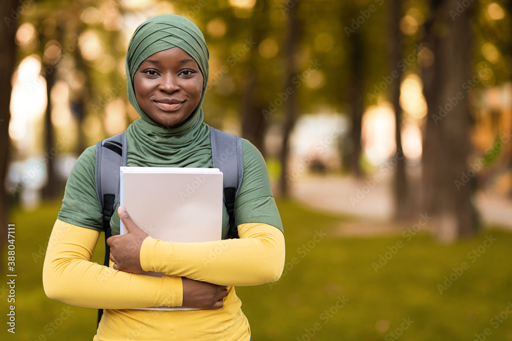 Education For Muslim Women. Black student lady in hijab posing outdoors - obrazy, fototapety, plakaty 