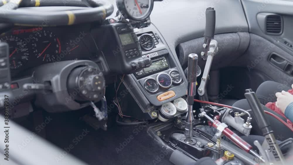 Cockpit of a sports car customized for track racing. Interior of a race car with the steering wheel taken away. Cockpit of a sports car customized for track racing. Interior of a race car with the steering wheel taken away.