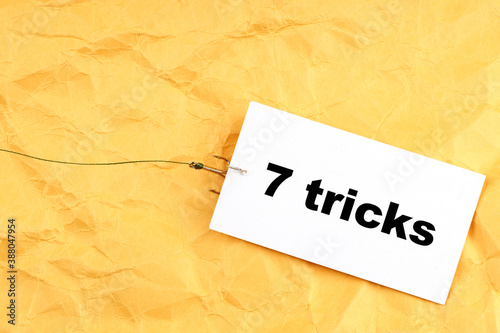fishhook paper with 7 Tricks written on it