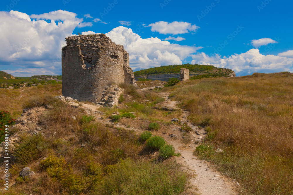 Ruins of an ancient fortress with the remains of a wall and dilapidated watchtowers in the city of Inkerman (Crimea)