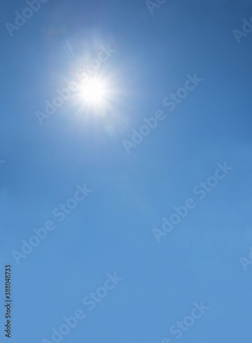 blue sky with shining sun, vertical shot