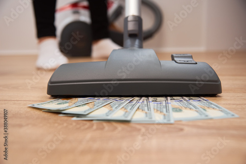 Vacuum cleaner suck usd dollar banknotes. Launder money concept