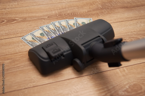 Vacuum cleaner suck usd dollar banknotes. Launder money concept
